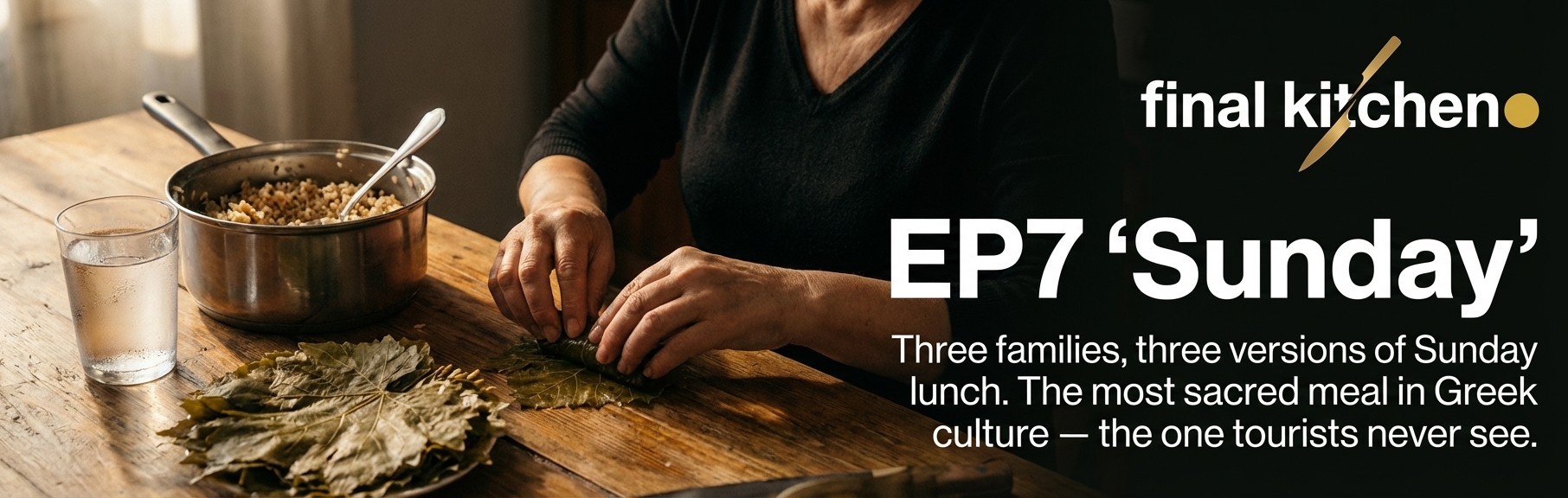 Hands rolling dolmades on a wooden table, copper pot of rice beside a glass of water